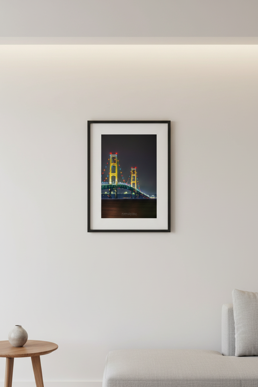 Small fine art portrait print of the Mackinac Bridge two towers lit up at night with colorful holiday lights displayed in modern living room