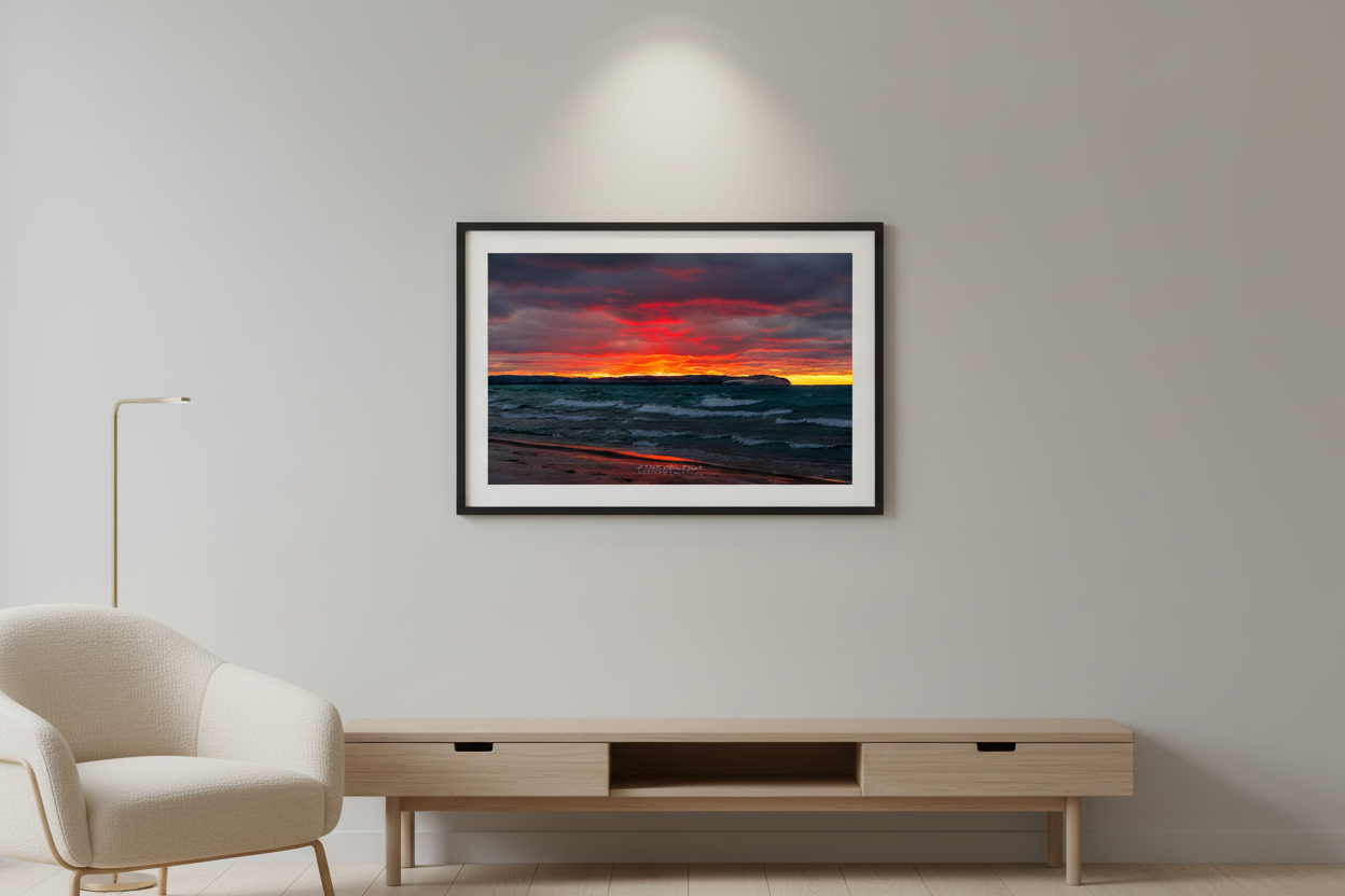 Small fine art landscape print of dramatic fiery sunset over lake with crashing waves displayed in modern living room