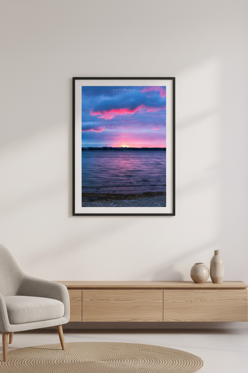 Large fine art portrait print of a vibrant pink and blue sunrise over West Grand Traverse Bay looking toward Old Mission Peninsula displayed in modern living room