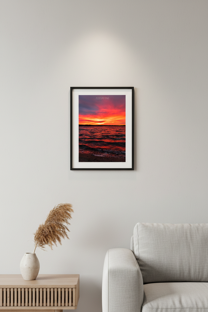 Small fine art portrait print of a fiery Lake Leelanau sunrise from Leland Michigan displayed in modern living room