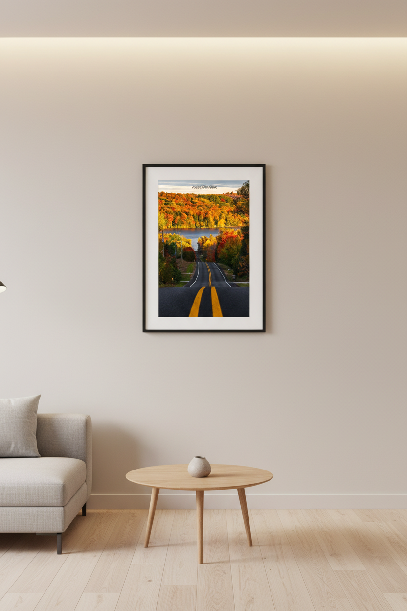 Small fine art portrait print of peak fall color road leading to a lake in Leelanau County Michigan displayed in modern living room