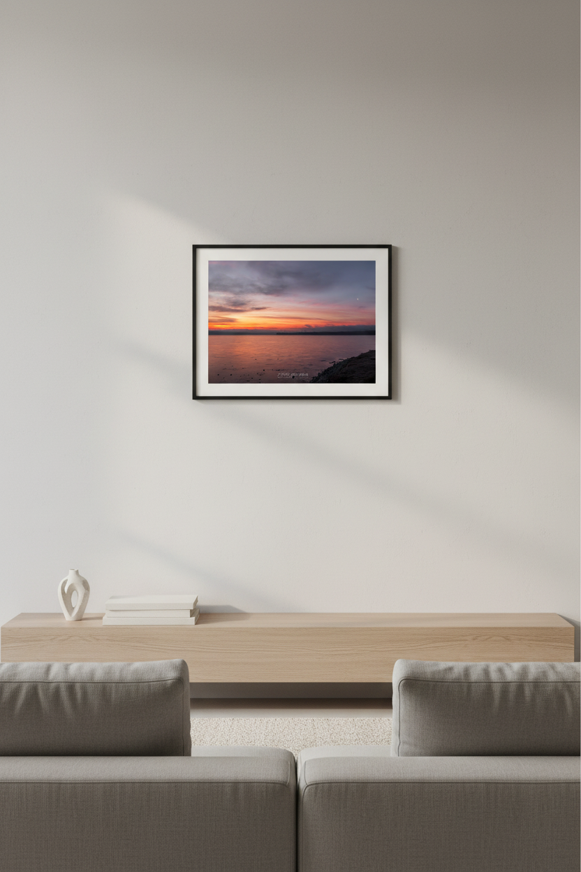 Small fine art landscape print of a fiery red sunrise with crescent moon over Lake Leelanau Michigan displayed in modern living room
